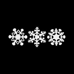 White paper snowflakes isolated on black. Handmade new year decoration