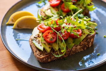 Vegan Avocado Toast with Tomatoes, Arugula, and Lemon - Healthy Breakfast