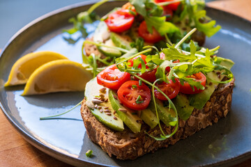 Vegan Avocado Toast with Tomatoes, Arugula, and Lemon - Healthy Breakfast