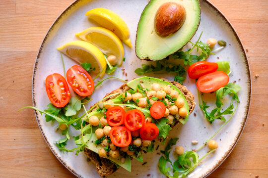 Vegan Avocado Toast with Chickpeas, Arugula, and Seeds - Healthy Breakfast
