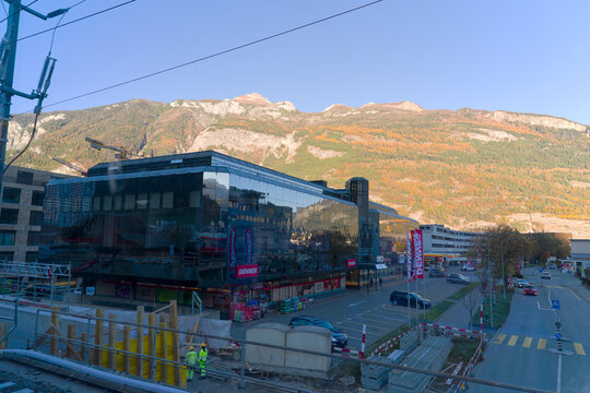 Scenic view of industrial district of Chur with mountain panorama with woodland in the background on a sunny autumn morning. Photo taken November 15th, Rhine Valley of Chur, Switzerland.