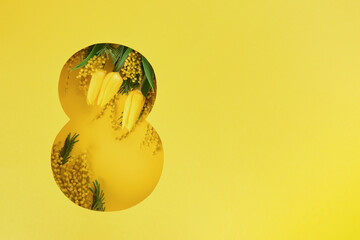8 March greeting card. Paper cut Eight made of yellow background and fresh spring flowers bouquet of yellow mimosa and tulips. Greeting card for International Womens day. Top view.