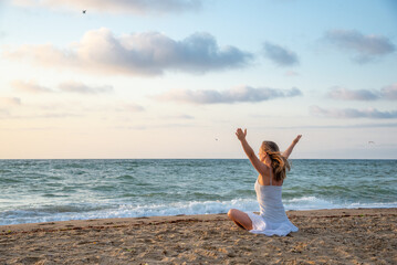 Woman meditating at the sea