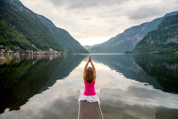 Woman meditating at the lake