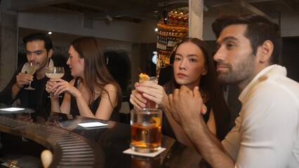 Friends or couple talking and drinking cocktail in Paloma, Margarita, Old fashioned and Martini glass celebrating special party beverage in vibrant nightclub making a toast with friendship. Vinosity.