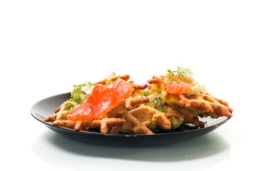 vegetable potato waffles with spread and lightly salted red fish in a plate