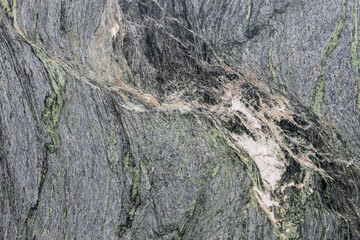 A fragment of natural gray-green marble, granite slab with interesting patterns