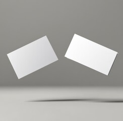 Blank business cards floating in space against a neutral background, perfect for showcasing your design ideas or branding concepts creatively and innovatively in your projects.