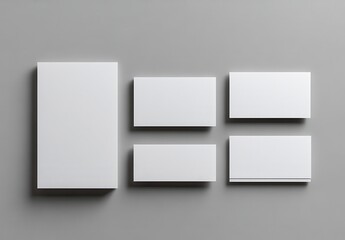 Clean and Minimalist Arrangement of Blank Business Cards and Stationery on a Soft Gray Background for Elegant Branding and Design Mockups