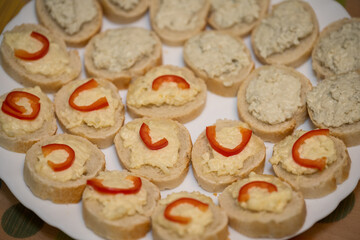 Niva cheese and garlic canapés with red pepper.
