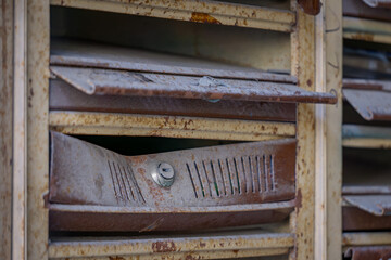 old antique historical post office boxes for letters in an abandoned tenement house in the city. devastated mailboxes in the stairwell