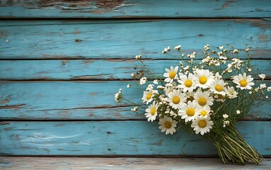 Obraz premium Rustic blue wood background with a bouquet of daisies.