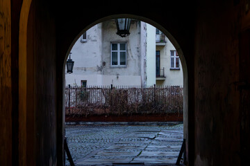 gate in an old tenement house in the evening, lighting of the yard in the tenement house. old...