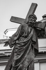 Obraz premium Sculpture of Jesus Christ with cross, black and white. Ancient monument of Jesus Christ in Lviv, Ukraine. Faith and sorrow concept. Old religious monument. Faith symbol and sign.