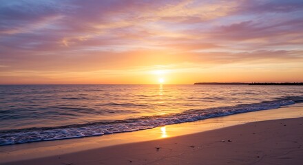 Fototapeta premium A serene beach at sunset with golden skies and soft waves