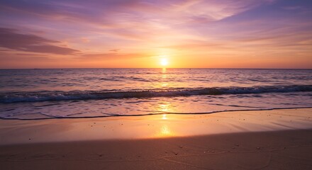 Fototapeta premium A serene beach at sunset with golden skies and soft waves