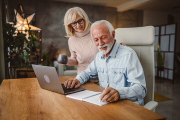 Senior wife take care of her husband while she work at home