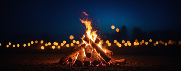 A burning bonfire on a dark blue background at night for Happy Lohri holiday or Punjabi festival. Traditional Indian festival. Backdrop for Bonfire Night festivities banner or poster with copy space.