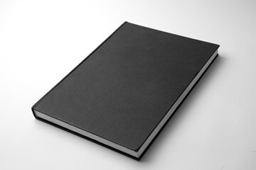 Blank black vertical book cover isolated on white paper background.