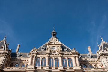 Looking up at the Palais de la Bourse de Lyon on clear day with deep blue sky
