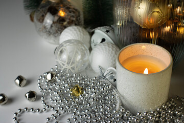 New Year decorations and candles on a white background. Christmas decorations close-up. Postcard, background for postcard, copy space