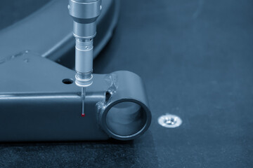 The  CMM probe measuring the  aluminum automotive parts.