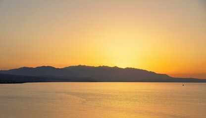 Fototapeta premium Coastline with Cretan Sea at sunset in late summer on the island of Crete in Greece
