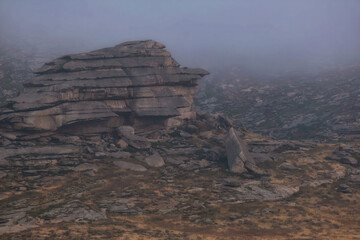Mystical rocks of bizarre shape in the fog , Kazakh small hills, monastery mountains in Eastern Kazakhstan in autumn.