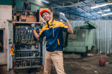 Skilled Worker in Industrial Workshop Poses Confidently With Tools in Hand