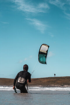 Kite Surfer Riding Waves on Cornwall Beach, UK - Extreme Water Sport Adventure, Active Lifestyle, Summer Fun, and Coastal Windsurfing Action