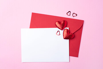 Red greeting envelope on pink background
