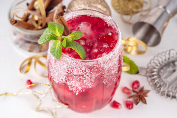 Spiced up winter berry Margarita cocktail or mocktail with orange, cranberry, pomegranate mint and crushed ice, Sweet non-alcohol or alcohol vodka drink for Christmas party