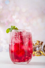 Spiced up winter berry Margarita cocktail or mocktail with orange, cranberry, pomegranate mint and...