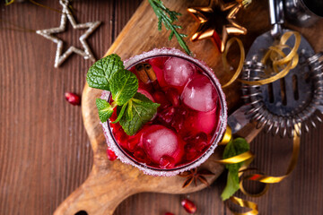 Spiced up winter berry Margarita cocktail or mocktail with orange, cranberry, pomegranate mint and crushed ice, Sweet non-alcohol or alcohol vodka drink for Christmas party