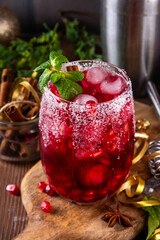 Spiced up winter berry Margarita cocktail or mocktail with orange, cranberry, pomegranate mint and...