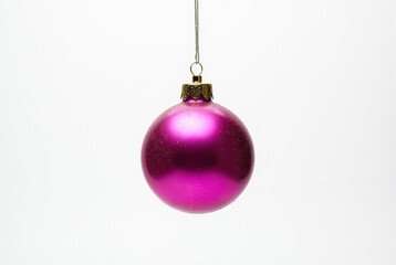 A single pink Christmas ornament with a glittery texture