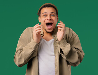 Shocked african american man glad, screaming WOW. Impressed guy, unbelievable