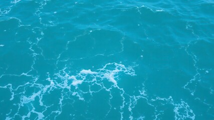 Pure blue turquoise water with white foam from crashing waves, sea, waves, ocean