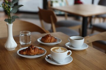 Delicious breakfast served on wooden table in cafe