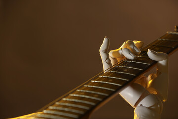 Artificial intelligence. Robot hand playing guitar on brown background, closeup