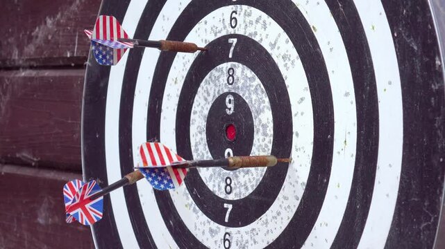 A close-up view of a dartboard with darts in the bullseye, highlighting the precision of the throws in 4k