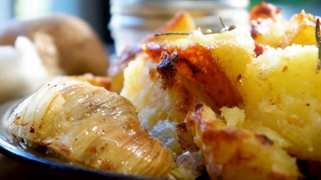 Cooking garlic rosemary roasted potatoes for dinner as a side dish.  Baking potatoes with fresh rosemary and garlic made in the oven.