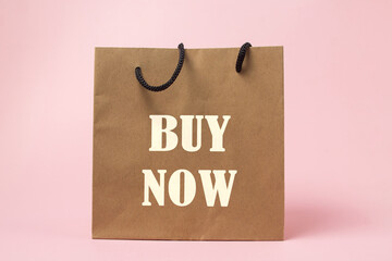 Paper bag with the inscription Buy now. Trading promotions