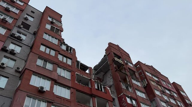 Russian missile hits residential building in Dnipro, Ukraine. Aftermath of enemy attack on city. Destroyed residential multi-story building. Close-up. War. Aftermath of explosion.