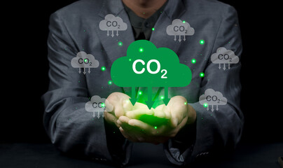 Hand holding CO2 reducing icon for decrease carbon dioxide emission, Business and environment sustainable, industry and company Reduce of carbon emissions to Net zero greenhouse gas target..
