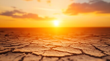 Dramatic Sunset Over Cracked Drought-Stricken Landscape Symbolizing Climate Crisis Urgency