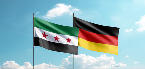 The new Syrian flag and the German flag are waving in the sky