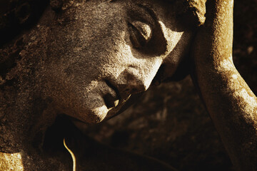 Close up sad angel as symbol of pain, death and end of life. Horizontal image.