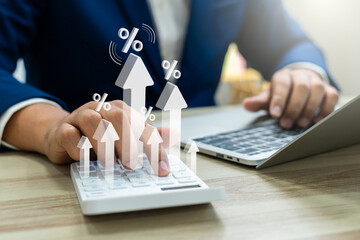 Interest rate concept, Business man using calculator with graph percentage symbol and up arrow,...