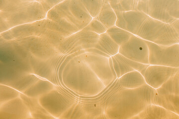 Soft ripples and sun glare on the bottom of the pool. Painting in yellow and orange tones. Natural...